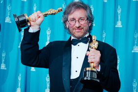 Steven Spielberg holding his two Oscars at the 1994