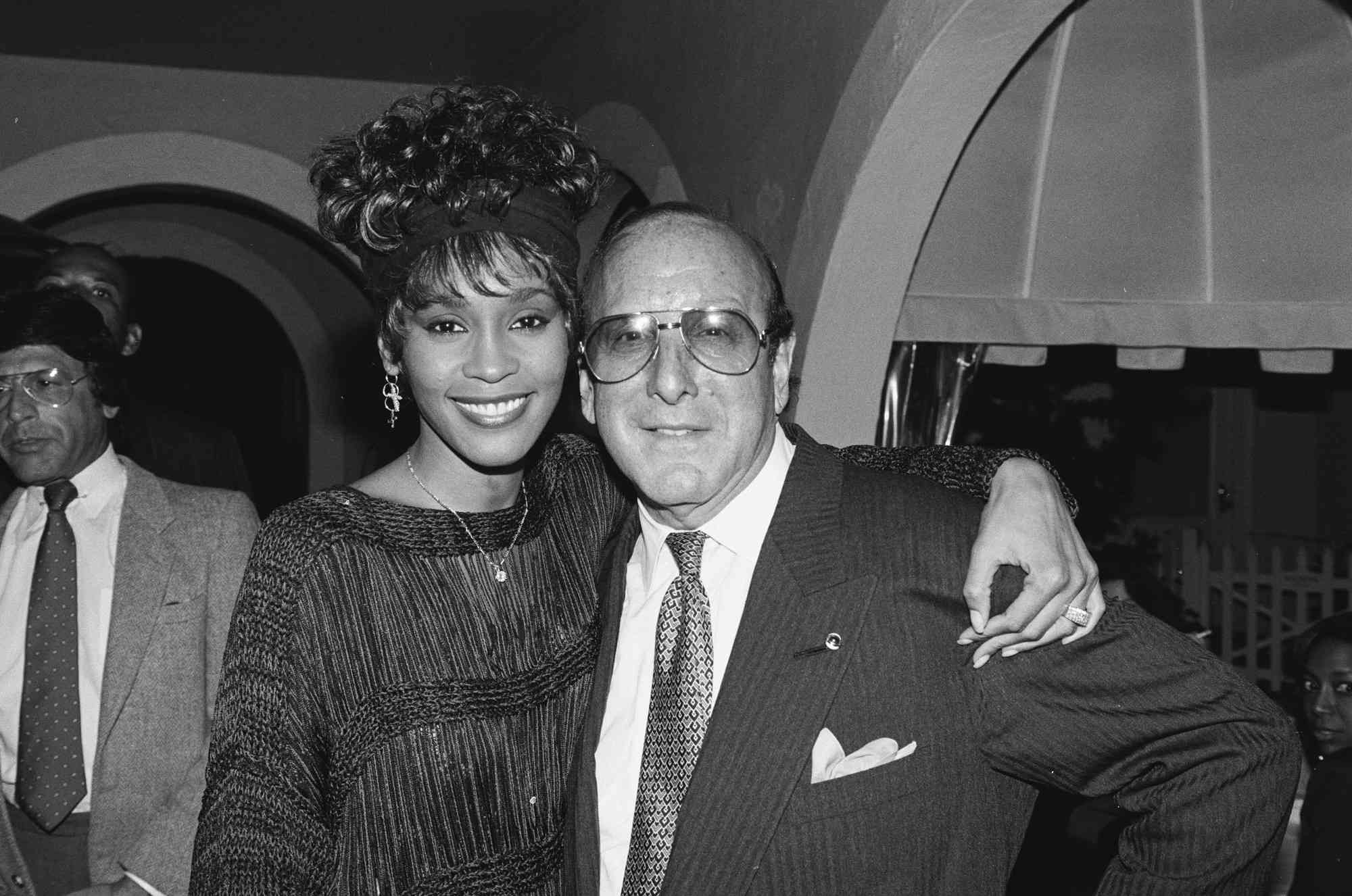 Whitney Houston and Clive Davis attend a party circa 1989.