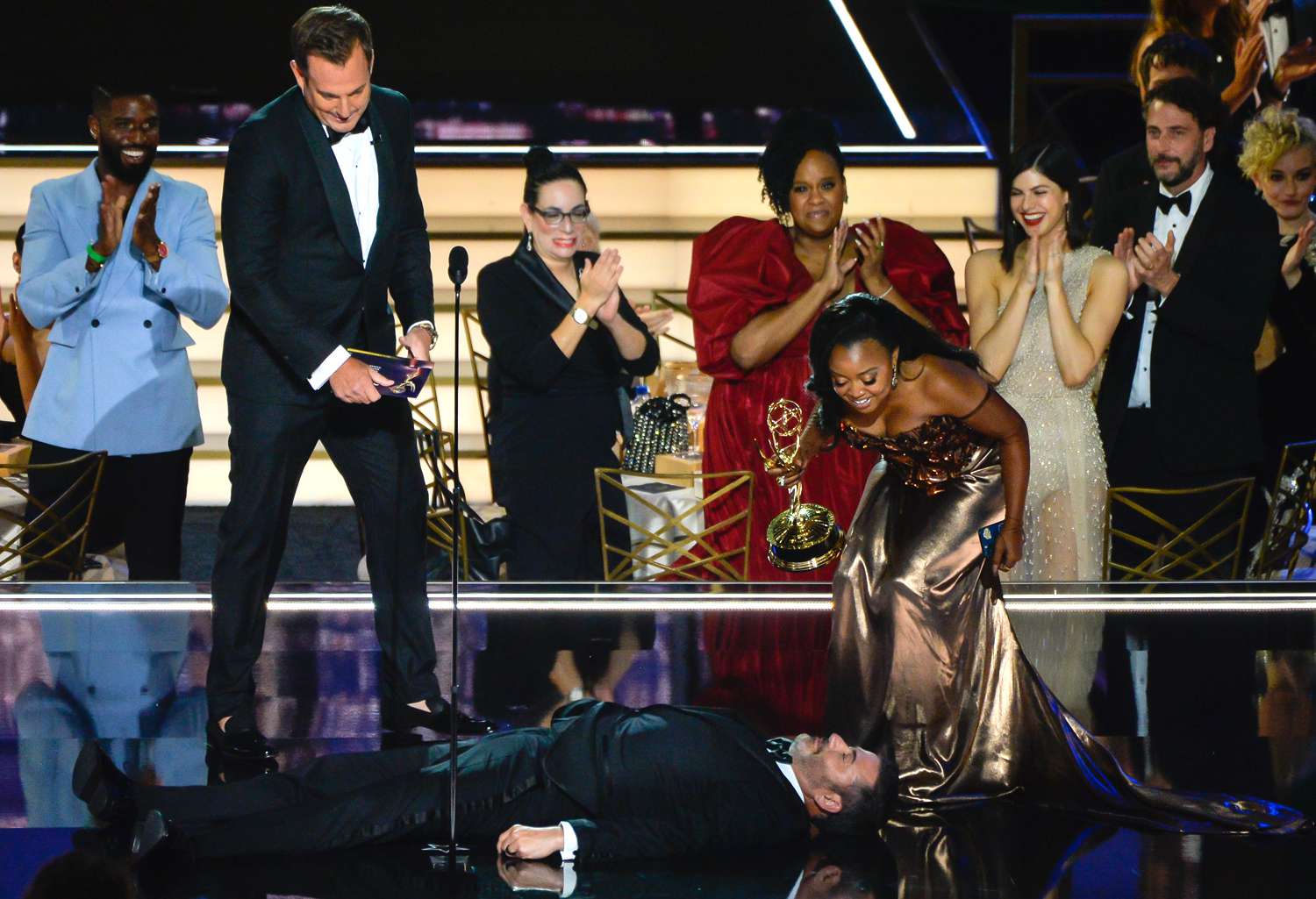 Quinta Brunson (R) accepts the Outstanding Writing for a Comedy Series award for 'Abbott Elementary' from Will Arnett and Jimmy Kimmel onstage during the 74th annual Primetime Emmy Awards