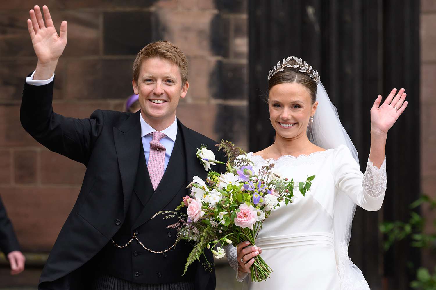 Hugh Grosvenor, Duke of Westminster and Olivia Grosvenor, Duchess of Westminster wave and smile to well-wishers after their wedding ceremony at Chester Cathedral 