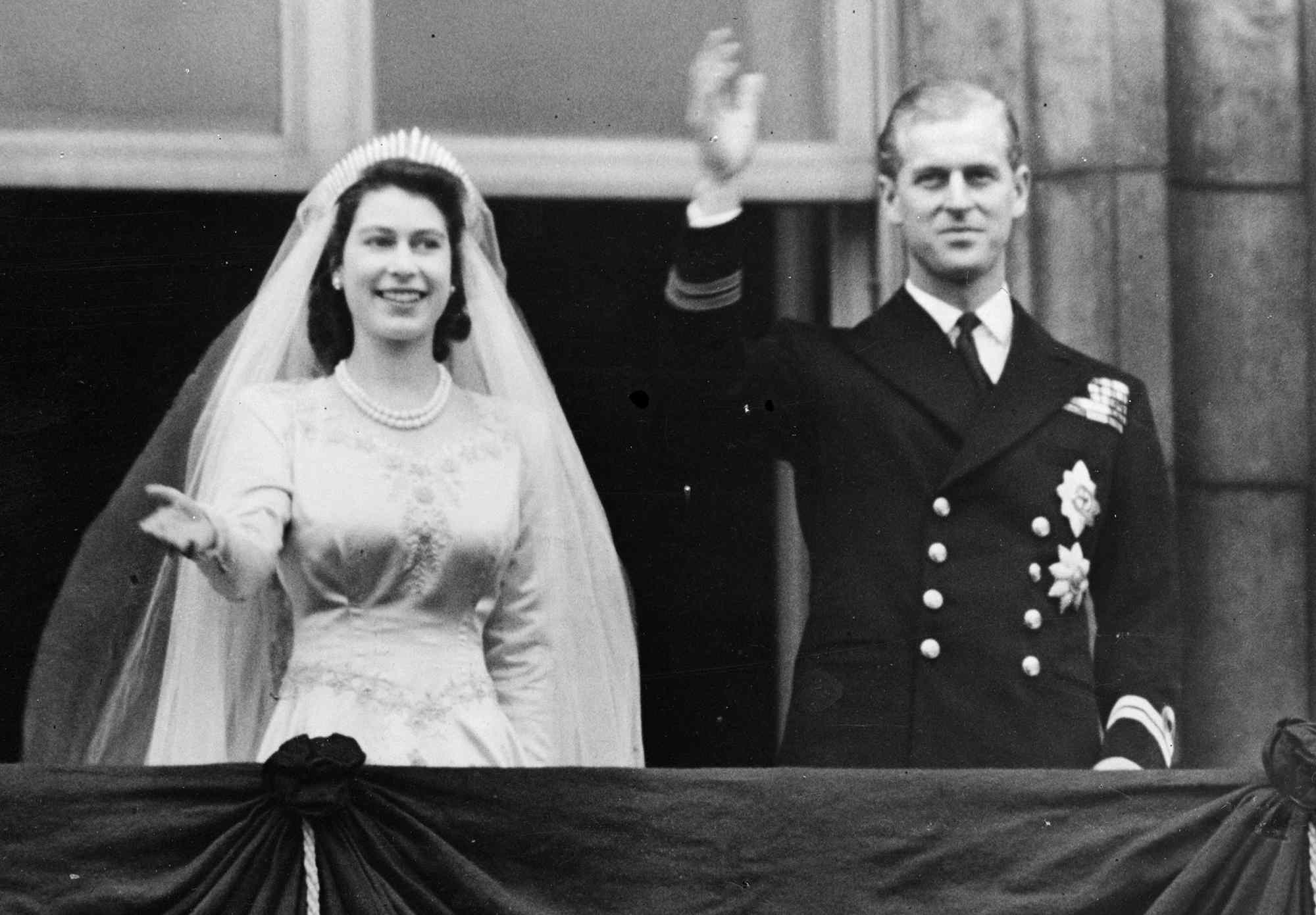 Princess Elizabeth and The Prince Philip, Duke of Edinburgh waving to a crowd from the balcony of Buckingham Palace, London shortly after their wedding at Westminster Abbey