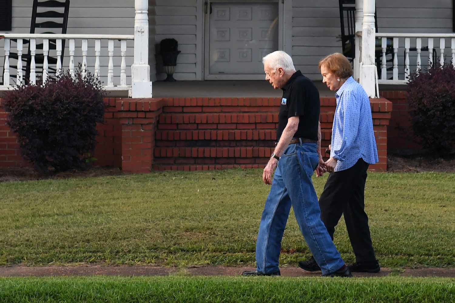 Former President of the United States, Jimmy Carter walks with his wife, former First Lady, Rosalynn Carter along with Secret Service along West Church Street following dinner at a friend's home on Saturday August 04, 2018 in Plains, GA. Born in Plains, GA, President Carter stayed in the town following his presidency