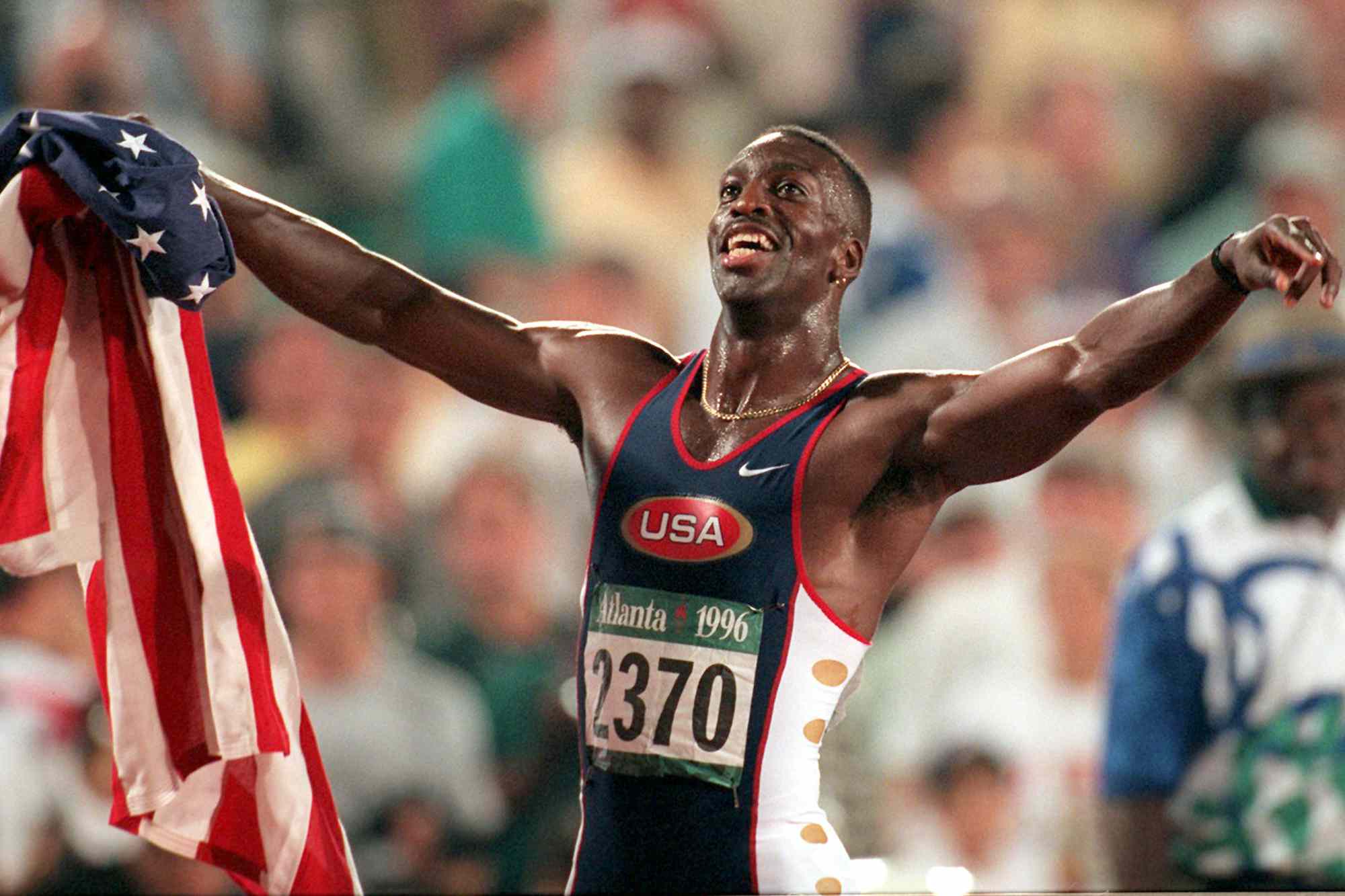 Michael Johnson of the United States celebrates after winning gold in the men's 200 meters in a new world record time of 19.32 at the 1996 Summer Olympic Games in Atlanta, Thursday August 1, 1996.