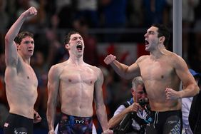 Gold medallists US' Caeleb Dressel, US' Hunter Armstrong, US' Chris Guiliano and US' Jack Alexy celebrate following the final of the men's 4x100m freestyle relay swimming event at the Paris La Defense Arena in Nanterre, west of Paris, on July 27, 2024.