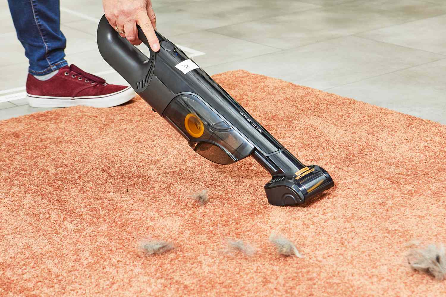 Shark UltraCyclone Pet Pro+ Cordless Handheld Vacuum used to clean dust on the carpet