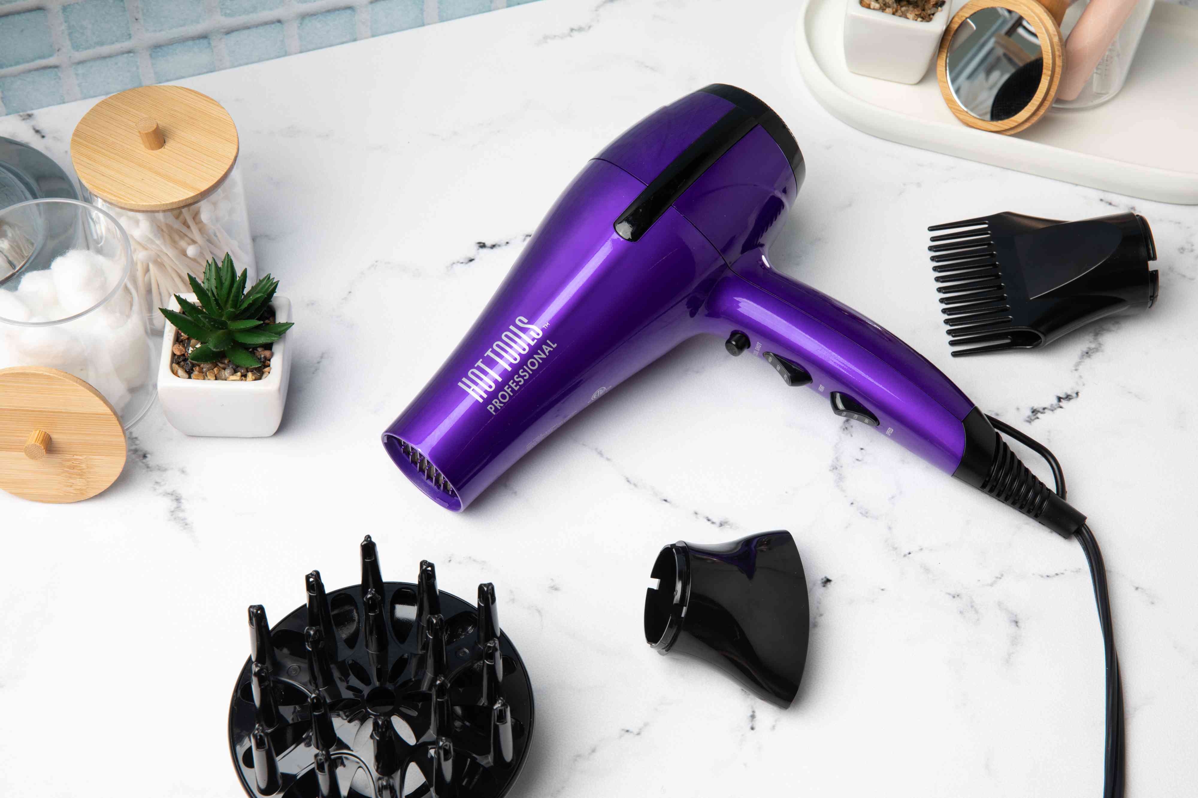 Hot Tools Turbo Ceramic Ionic Dryer and accessories displayed on a marble counter