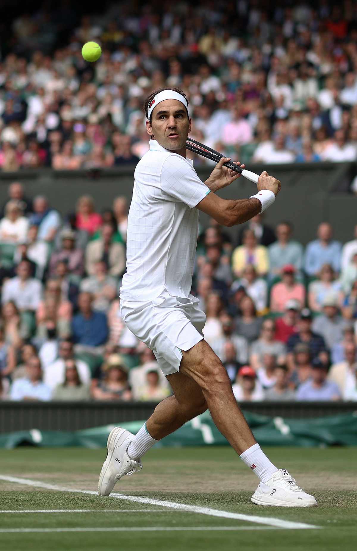 Roger Federer of Switzerland plays a backhand during his men's Singles Quarter Final match against Hubert Hurkacz of Poland on Day Nine of The Championships - Wimbledon 2021 at All England Lawn Tennis and Croquet Club on July 07, 2021 in London, England. 
