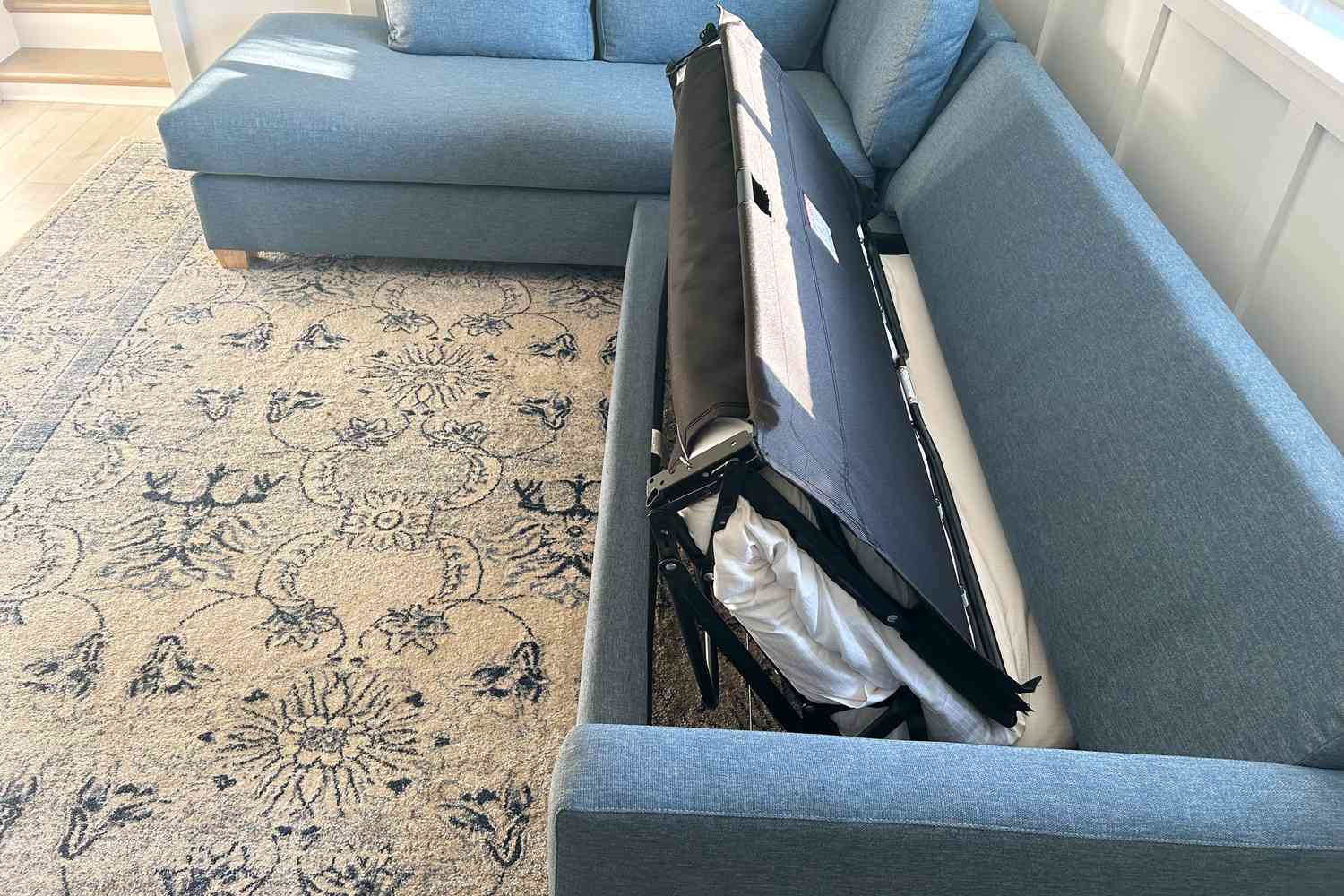 Bed of the Apt2B Tuxedo 2-Piece Sleeper Sectional partially pulled out over rug