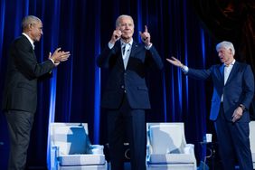 Former US President Barack Obama (L) and former US President Bill Clinton (R) cheer for US President Joe Biden