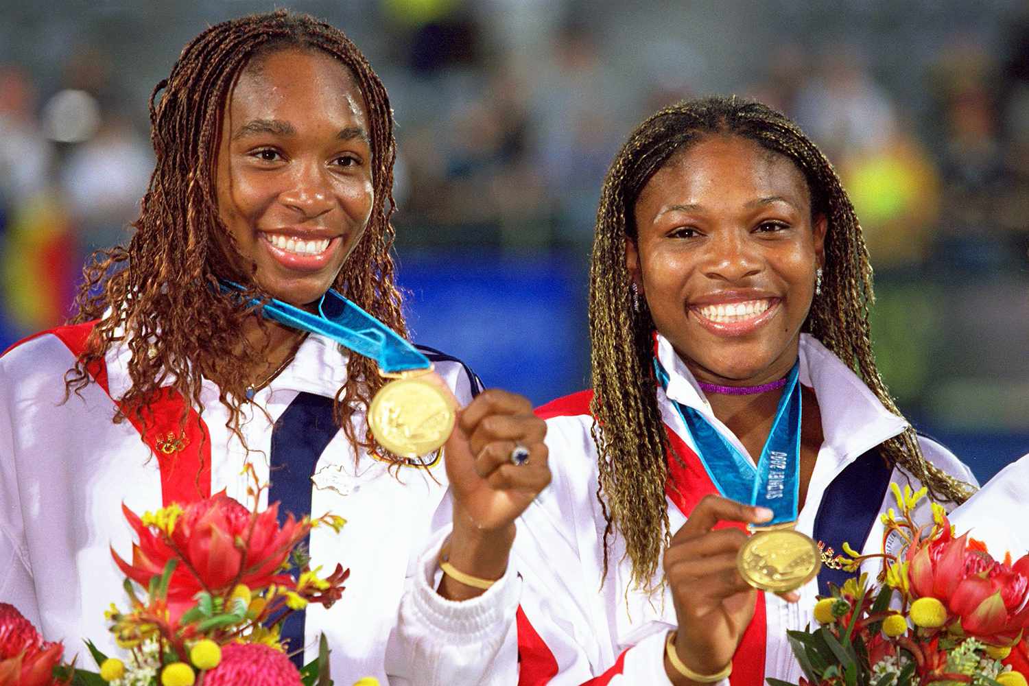 Venus and Serena Williams of the USA celebrate gold after winning the Womens Doubles Tennis Final at the NSW Tennis Centre on Day 13 of the Sydney 2000 Olympic Games in Sydney, Australia.