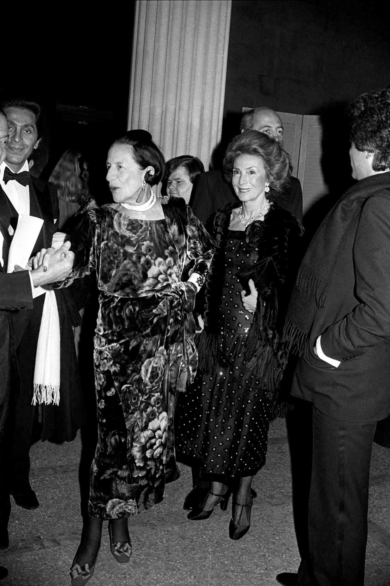 Diana Vreeland attends The Metropolitan Museum of Art's annual Costume Institute gala (designer Valentino in background).