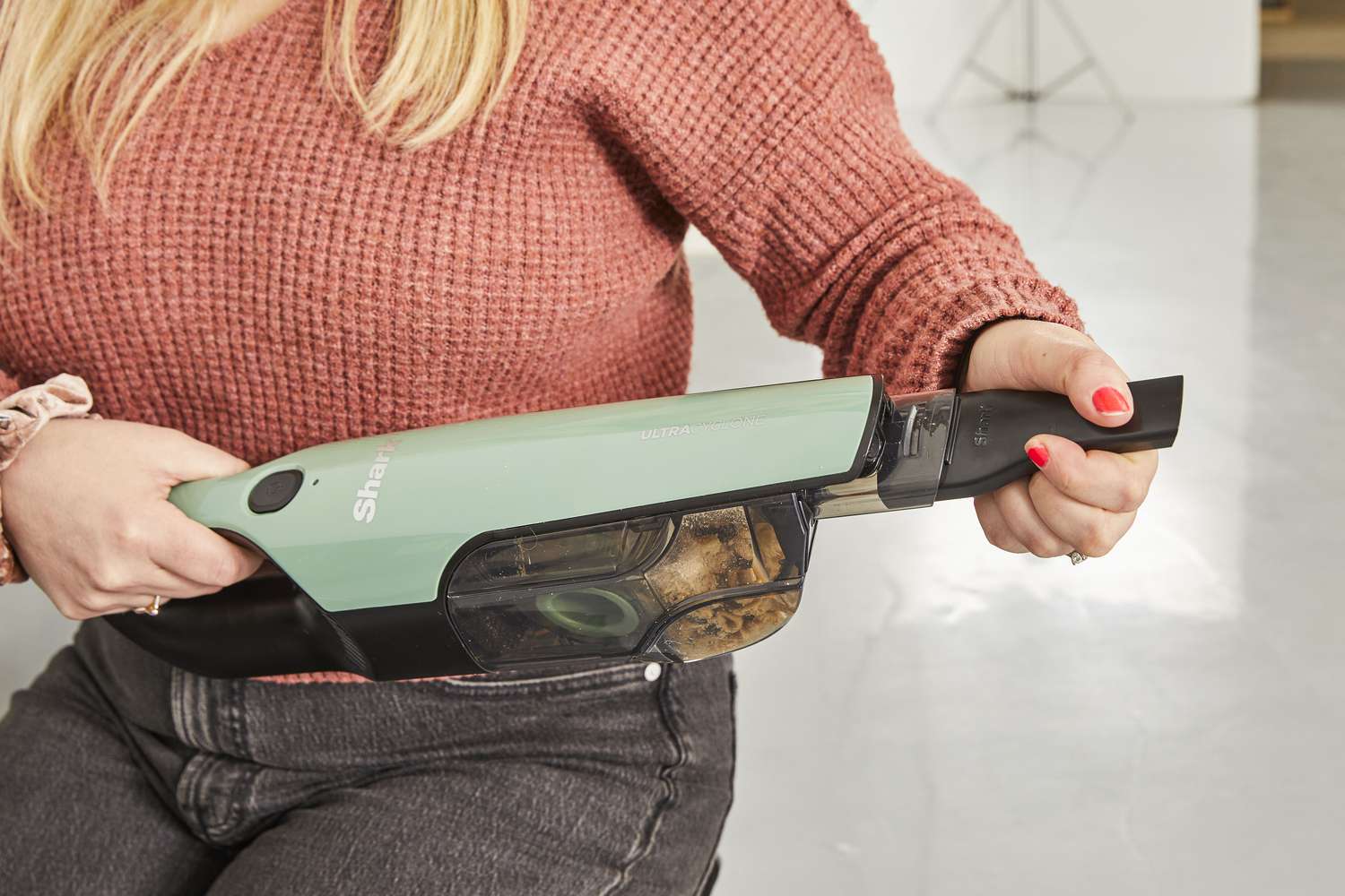 Person holding the nozzle of the Shark UltraCyclone Pro Cordless Handheld Vacuum