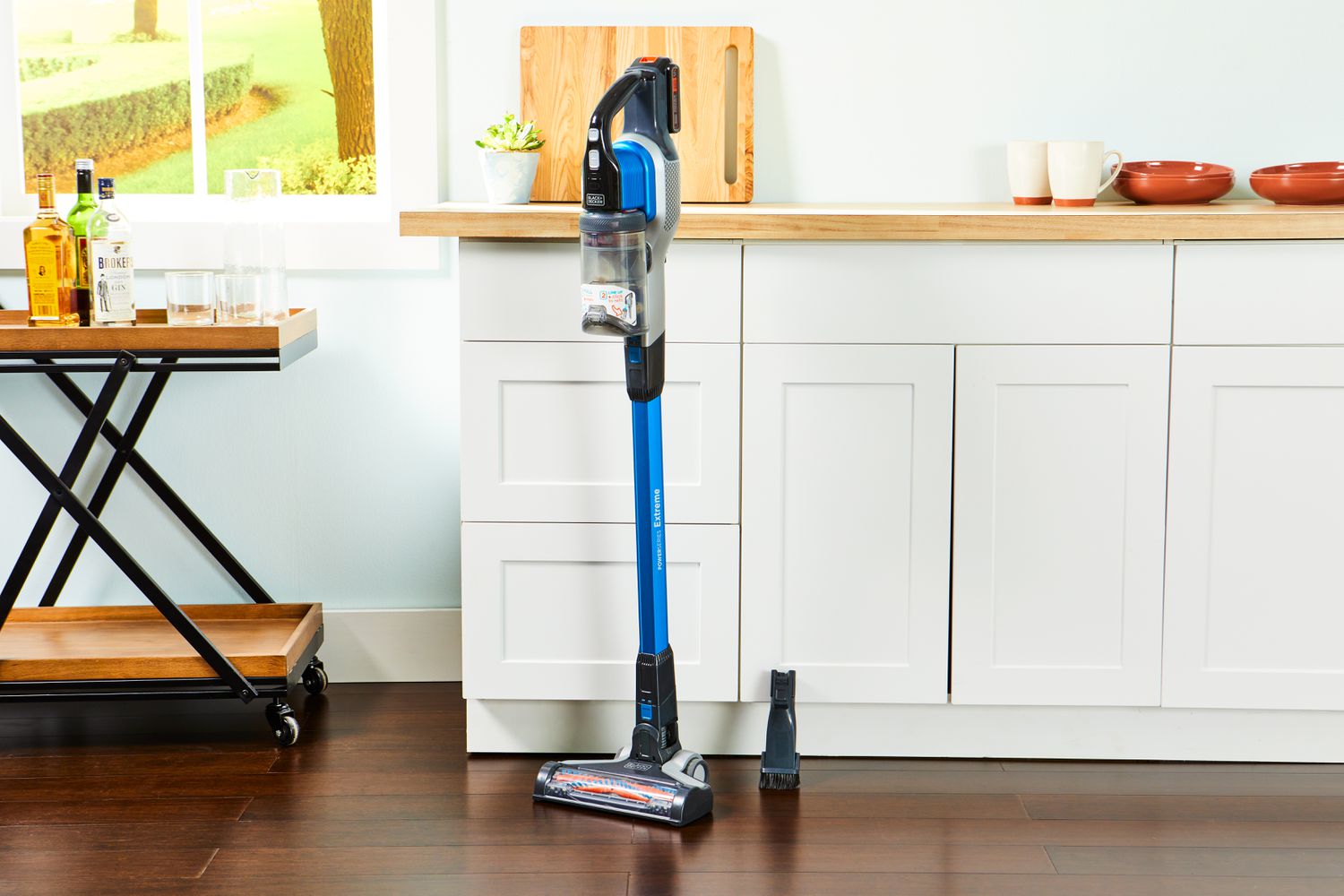BLACK+DECKER Powerseries Extreme Cordless Stick Vacuum Cleaner displayed in front of a kitchen counter