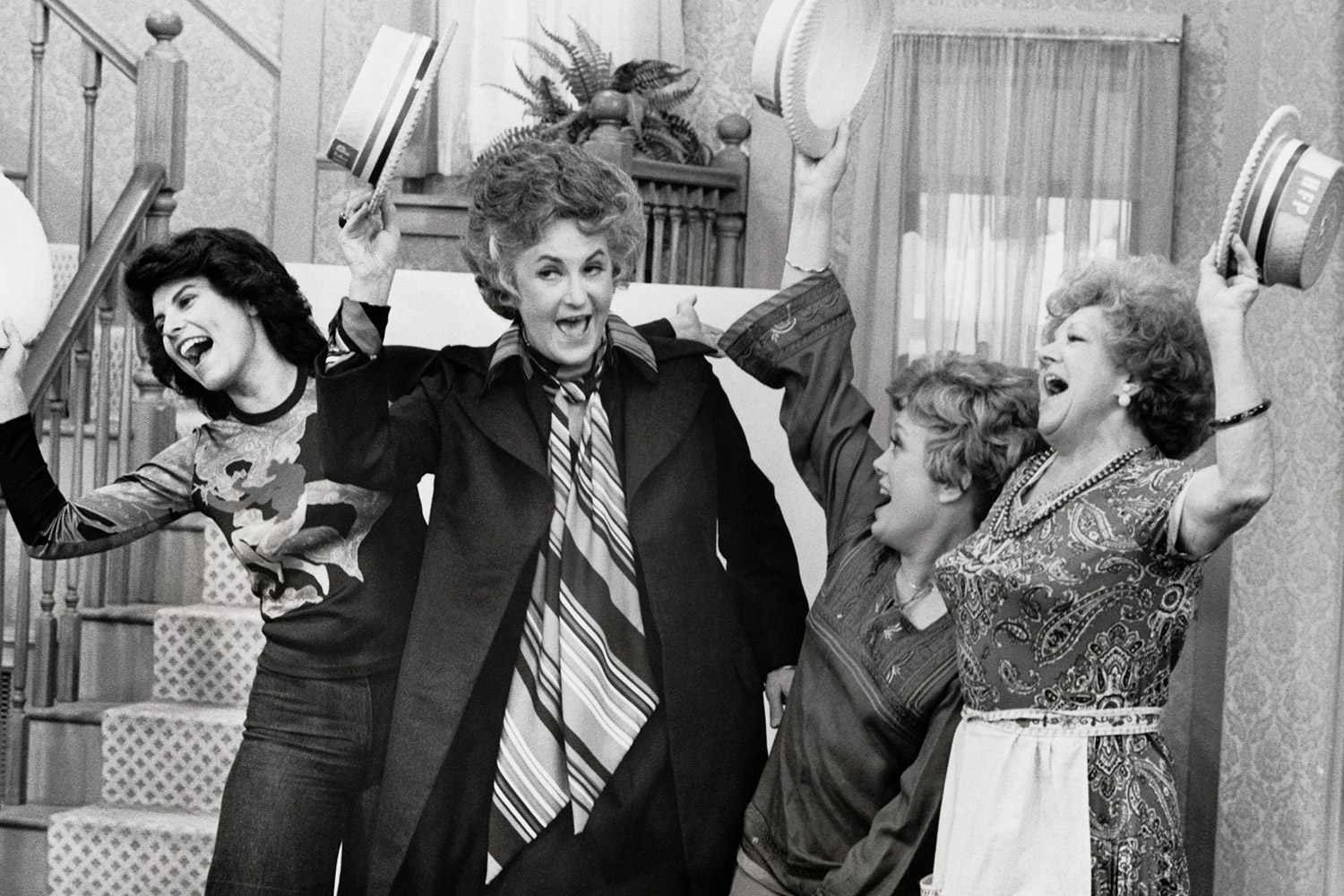 (Original Caption) Left to right, Carol (Adrienne Barbeau) joins Maude (Beatrice Arthur), who has launched a "Henry Fonda for President" campaign, in a rousing song, along with Vivian (Rue McClanahan) and Mrs. Naugatuck (Hermione Baddeley) on Maude, Monday, January 12th (9:30-10:00 P.M., ET) on the CBS Television Network.