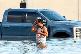 A man cools off while navigating flood waters following heavy rain from Hurricane Beryl in Houston, Texas, USA, 08 July 2024