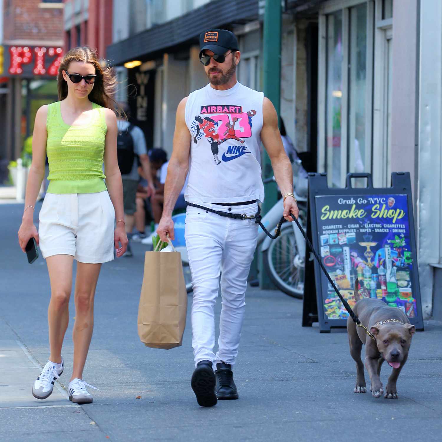 Justin Theroux and his girlfriend Nicole Brydon Bloom enjoy a humid day grocery shopping with his dog Kuma in New York City.