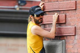 Jared Leto seen taking a break from a bike ride to climb a random building in New York City. The quirky actor sized up the building before climbing the facade.