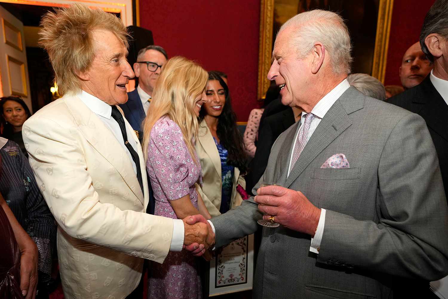 King Charles III, right, shakes hands with British pop icon Rod Stewart as they attend the inaugural King's Foundation charity awards at St James's Palace on June 11, 2024 in London, England. 