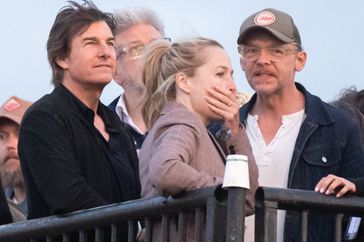 Tom Cruise, Gillian Anderson and Simon Pegg ahead of Coldplay performing during day four of Glastonbury Festival 2024 at Worthy Farm, Pilton on June 29, 2024 in Glastonbury, England.