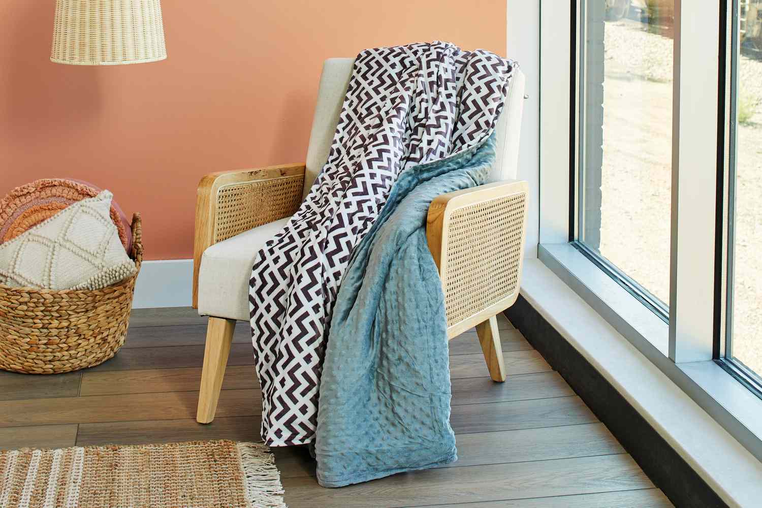 Quility Weighted Blanket for Adults on a chair next to a window and a basket