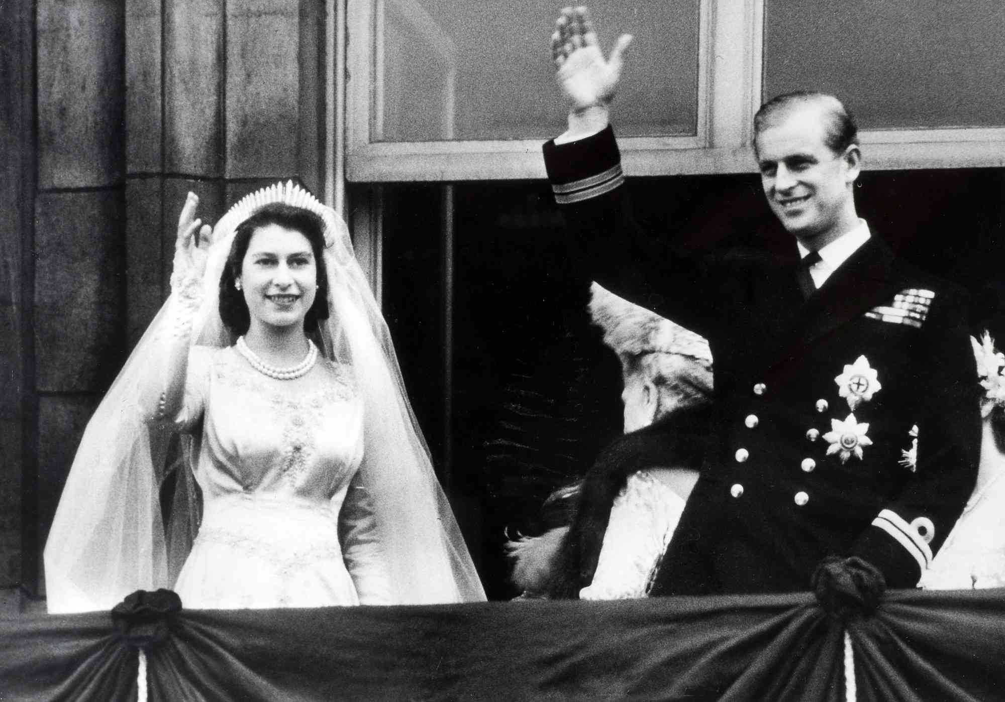 British Royalty. London, England. 20th November 1947. Princess Elizabeth (now The Queen) and Prince Philip, The Duke of Edinburgh wave to crowds from the balcony of Buckingham Palace following their marriage.