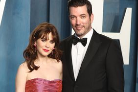 Zooey Deschanel and Jonathan Scott attend the 2022 Vanity Fair Oscar Party hosted by Radhika Jones at Wallis Annenberg Center for the Performing Arts on March 27, 2022 in Beverly Hills, California