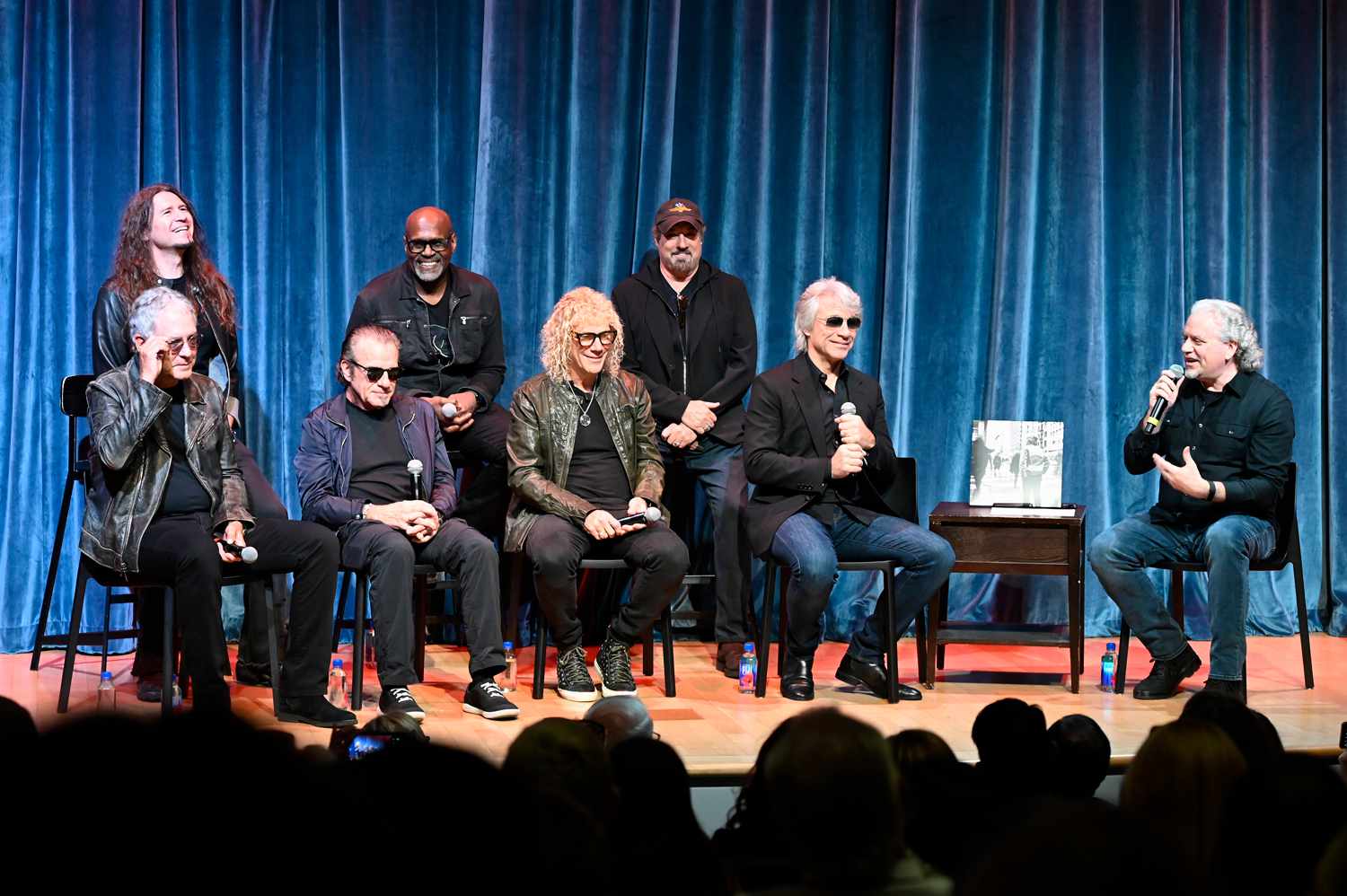 Phil X, Everett Bradley, John Shanks, Hugh McDonald, Tico Torres, David Bryan and Jon Bon Jovi speak on stage during a Q&A with Jason Hanley, Vice President of Education and Visitor Engagement at the opening of the "Bon Jovi Forever" exhibit at the Rock and Roll Hall of Fame and Museum on June 08, 2024 in Cleveland, Ohio. 