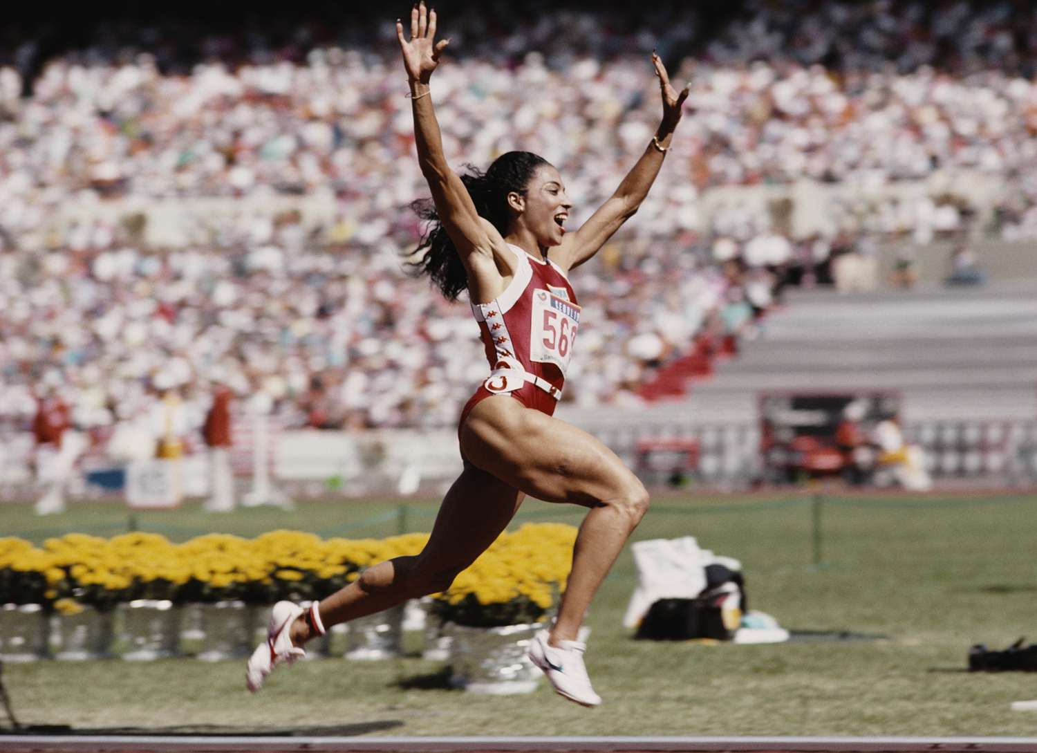 Florence Griffith-Joyner of the United States celebrates winning gold in the Women's 100 metres final event during the XXIV Summer Olympic Games on 25 September 1988 at the Seoul Olympic Stadium in Seoul, South Korea. 