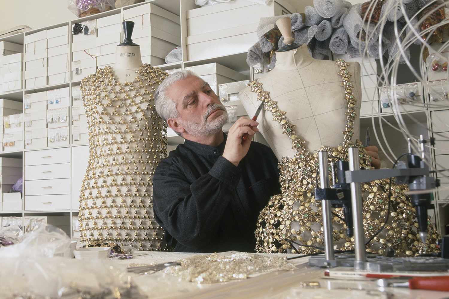 Paco Rabanne works on an outfit in his Paris workshop