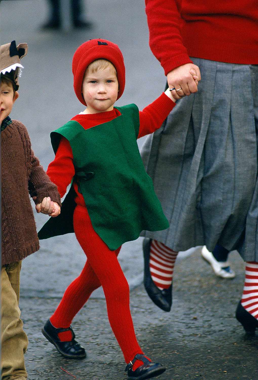 Prince Harry wearing a red and green ensemble for his school's nativity play in 1987 (circa).