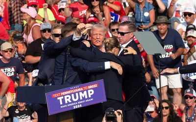 Republican candidate Donald Trump is seen with what appears to be blood on his face surrounded by secret service agents as he is taken off the stage at a campaign event at Butler Farm Show Inc. in Butler, Pennsylvania, July 13, 2024. 