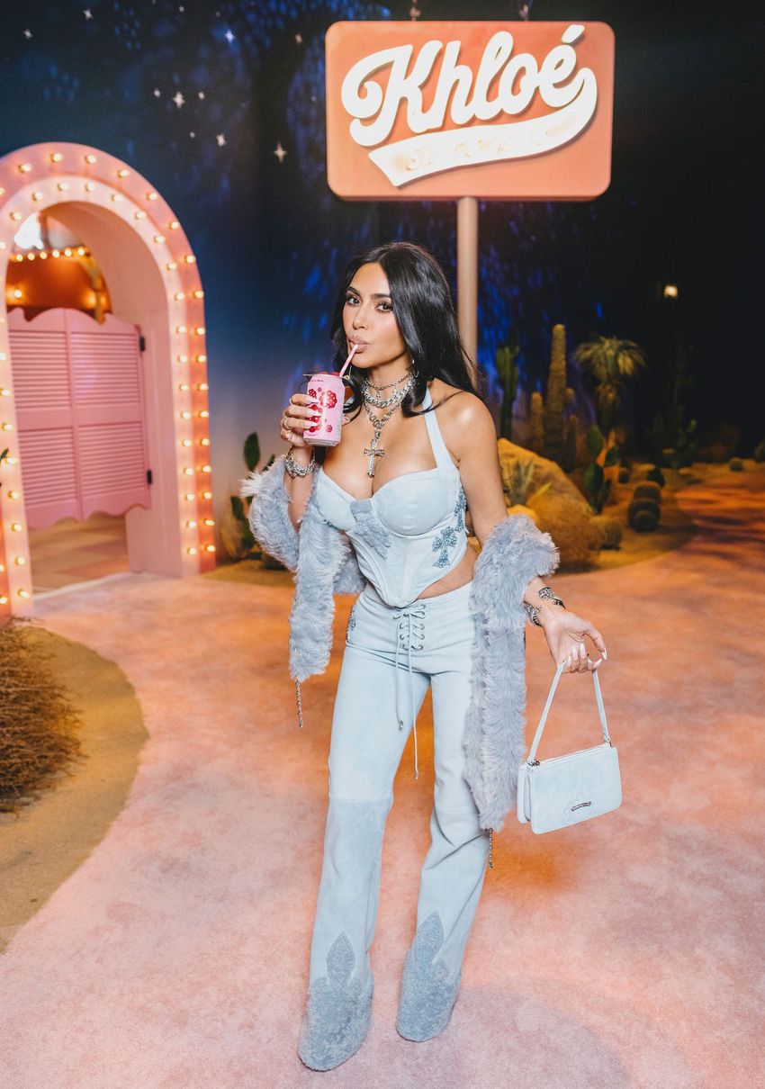 Kim Kardashian sips on a Raspberry Rose poppi soda while at sister Khloe's 40th birthday party in LA.