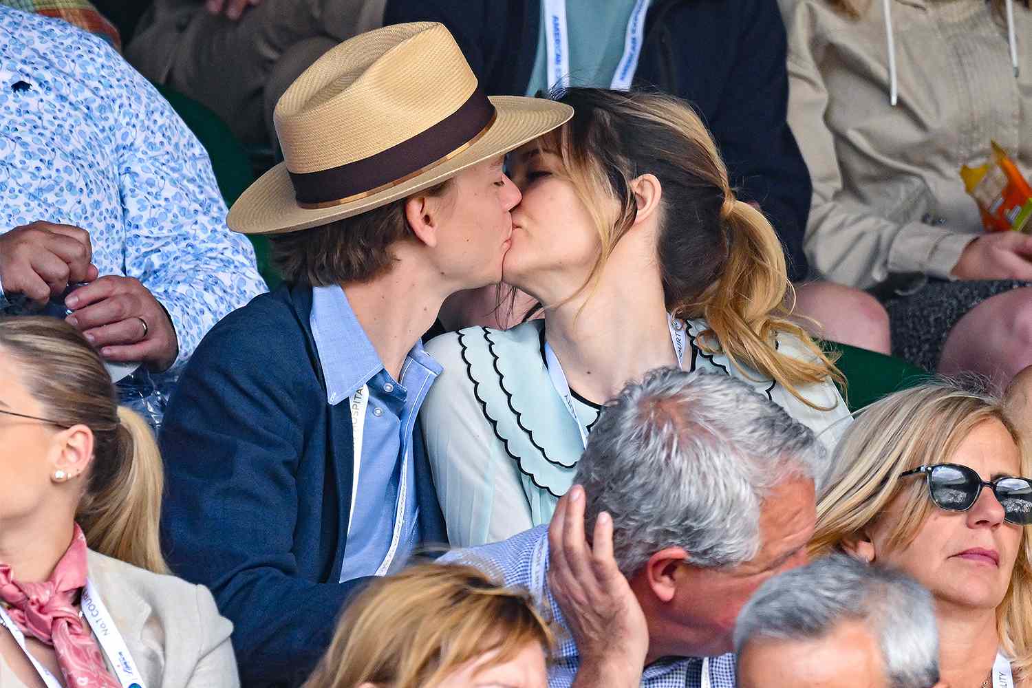 Thomas Brodie-Sangster and Talulah Riley kiss while watching a match in the Lanson champagne suite during Day Six of Wimbledon 2022 at All England Lawn Tennis and Croquet Club on July 02, 2022 in London, England.