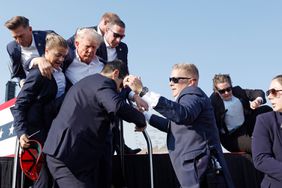  Republican presidential candidate former President Donald Trump is rushed offstage during a rally on July 13, 2024