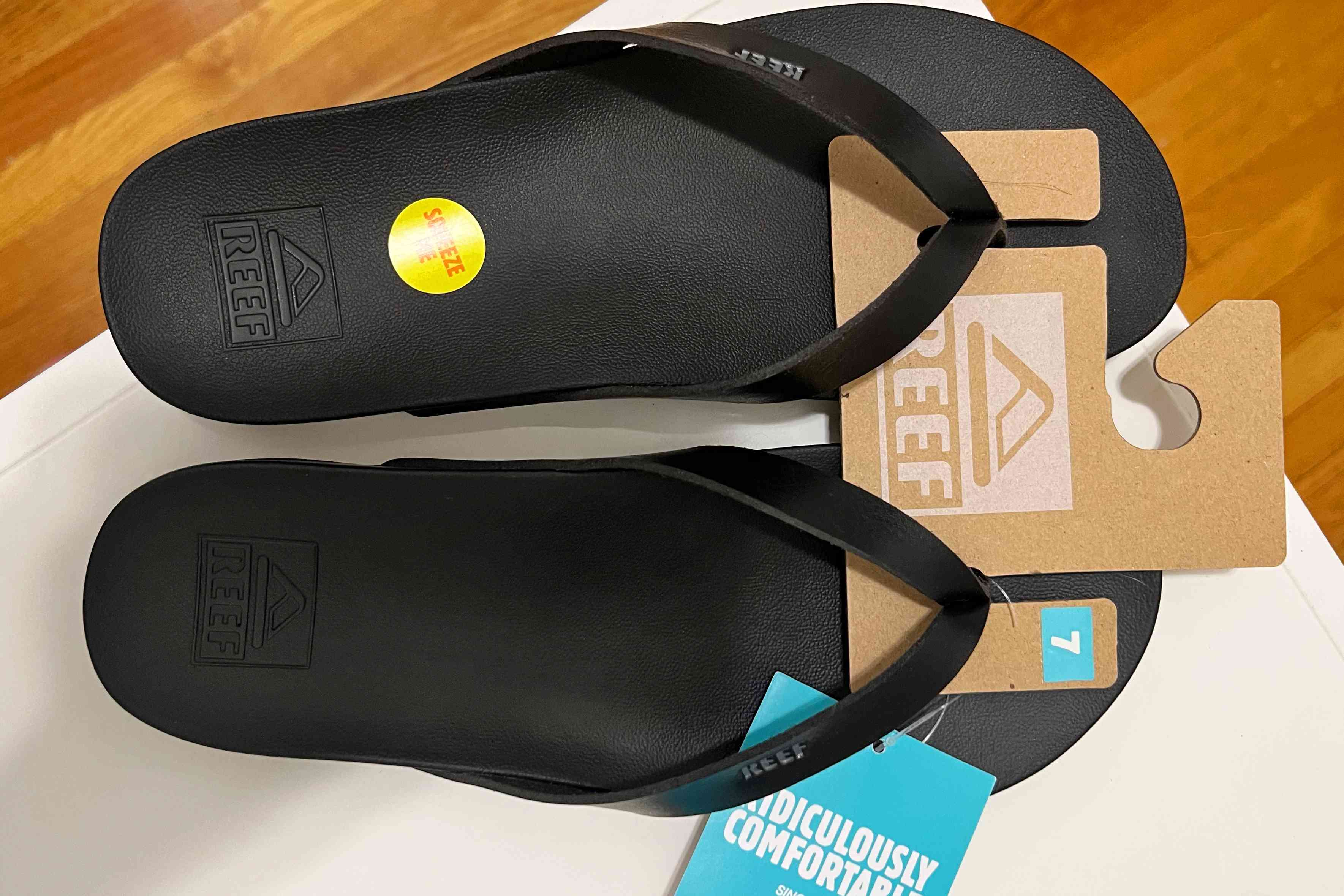 The top of the Reef Cushion Court Flip Flops with the tags still attached