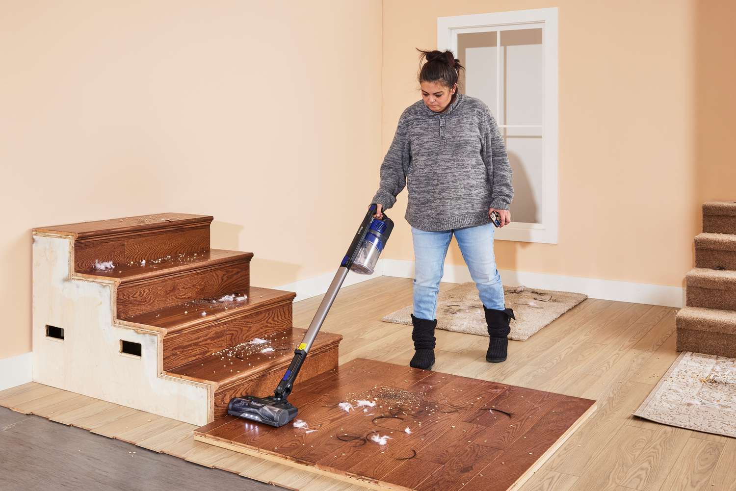 A person cleaning wooden stairs