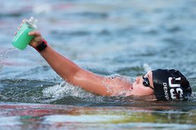 Mariah Denigan of Team United States has a drink as she competes in the Marathon Swimming Women's 10k on day thirteen of the Olympic Games Paris 2024 at Pont Alexandre III on August 08, 2024 in Paris, France