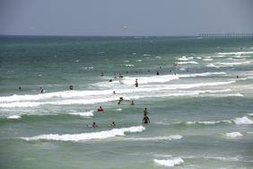 People swim at a beach in Panama City, Florida, U.S., on Friday, July 31, 2020
