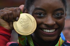 RIO DE JANEIRO, BRAZIL - AUGUST 09: Simone Biles of the United States shows of her Gold medal after the Artistic Gymnastics Women's Team Final on Day 4 on Day 4 of the Rio 2016 Olympic Games at the Rio Olympic Arena on August 9, 2016 in Rio de Janeiro, Brazil. (Photo by Images)