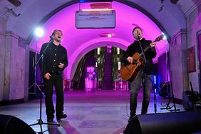 Bono (Paul David Hewson), Irish singer-songwriter, activist, and the lead vocalist of the rock band U2, and guitarist David Howell Evans (R) aka 'The Edge', perform at subway station which is bomb shelter, in the center of Ukrainian capital of Kyiv on May 8, 2022