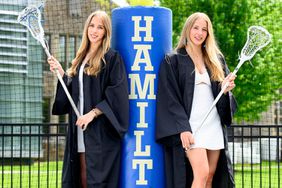 Twins, co-valedictorians and lacrosse players Olivia left, and Chloe Chiota, right, pose on Steuben Field at Hamilton College on Friday, May 17, 2024 in Clinton, NY.