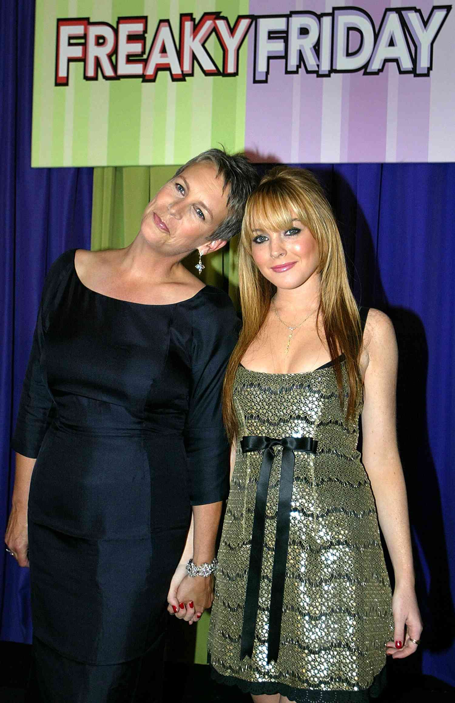 Jamie Lee Curtis (L) and actress Lindsay Lohan (R), stars of the new Disney film "Freaky Friday," pose as they arrive for the premiere of the movie