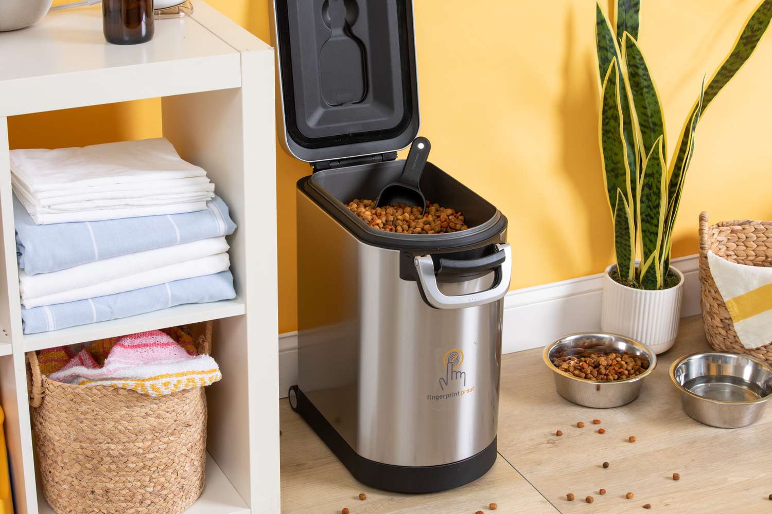 Simplehuman Pet Food Storage Can full of dog food in orange room