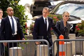 Hunter Biden (C), son of US President Joe Biden, joined by his wife Melissa Cohen Biden, arrives to the J. Caleb Boggs Federal Building