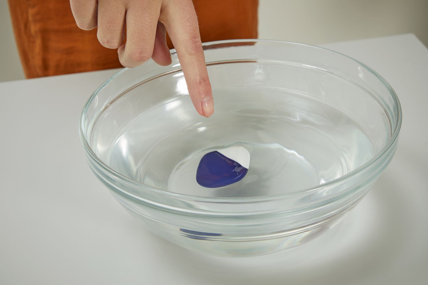 PETFON Pet GPS Tracker floating in a bowl of water