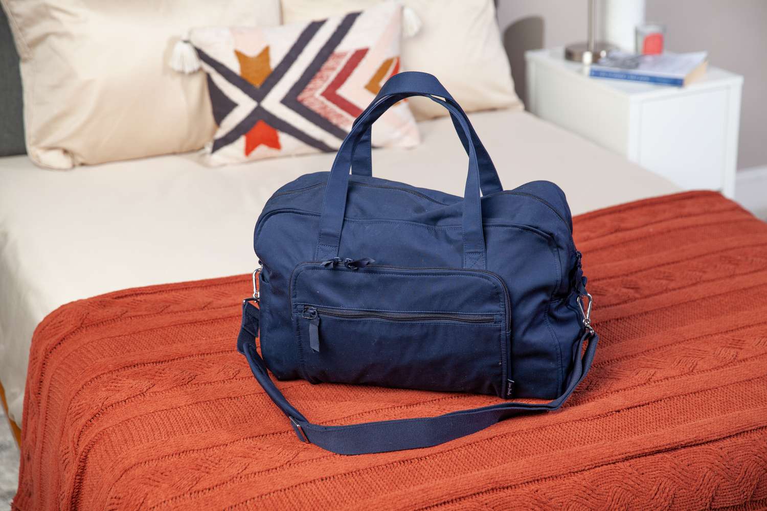 Vera Bradley Weekender Travel Bag displayed on bed