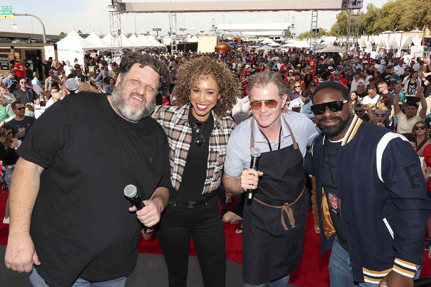 Aaron May, Sage Steele, Bobby Flay, and DJ Irie attend The Players Tailgate Hosted By Bobby Flay and presented by Bullseye Event Group for Super Bowl 57