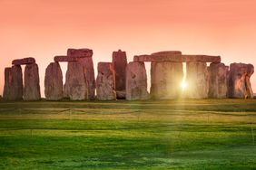 The prehistoric monument of Stonehenge in England. Focus is on the grass.