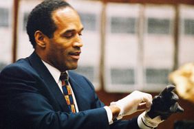 O.J. Simpson tries on a leather glove allegedly used in the murders of Nicole Brown Simpson and Ronald Goldman during testimony in Simpson's murder trial June 15, 1995 in Los Angeles