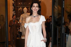 Anne Hathaway wears a custom Gap white shirt dress designed by Gap Inc.âs Creative Director Zac Posen at a Bulgari event in Rome, Italy.